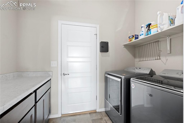 laundry room with baseboards and separate washer and dryer