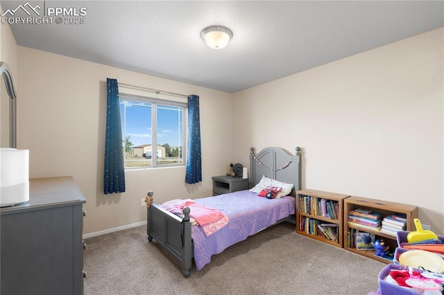 bedroom featuring baseboards and light colored carpet