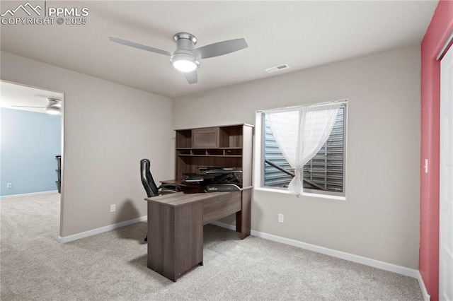 home office with baseboards, a ceiling fan, visible vents, and light colored carpet