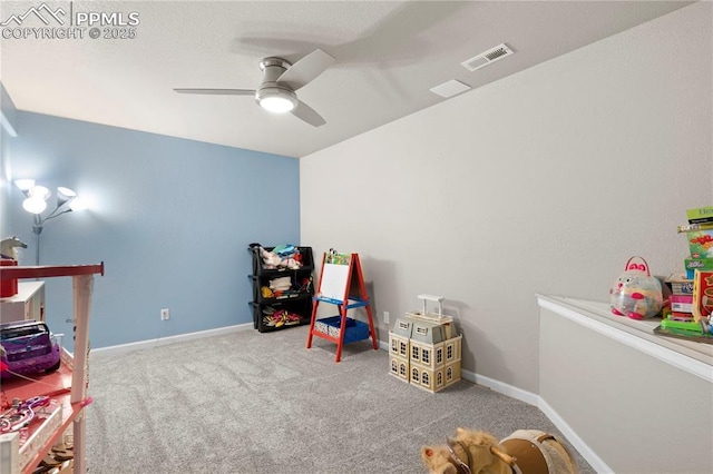 rec room featuring a ceiling fan, light carpet, visible vents, and baseboards