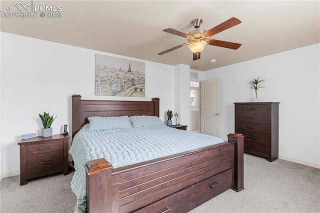 bedroom with a ceiling fan, light carpet, and baseboards