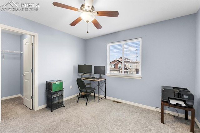 office area with light carpet, ceiling fan, and baseboards