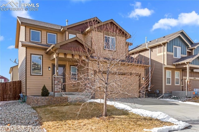 craftsman-style house featuring driveway, an attached garage, and fence