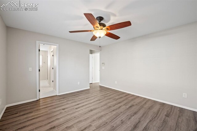 unfurnished bedroom with wood finished floors, a ceiling fan, and baseboards