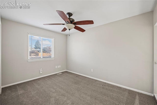 empty room featuring ceiling fan, dark carpet, visible vents, and baseboards