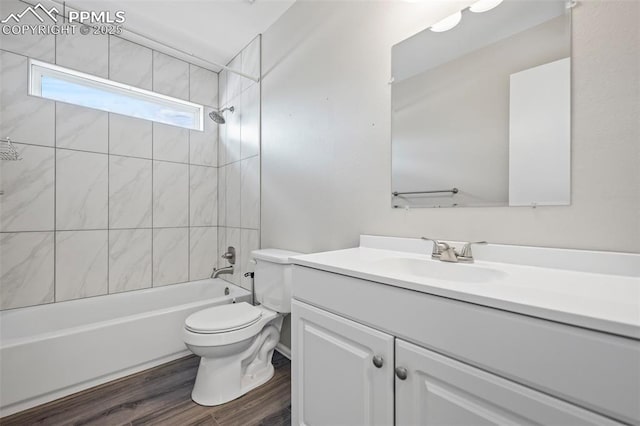 bathroom featuring wood finished floors, bathing tub / shower combination, vanity, and toilet