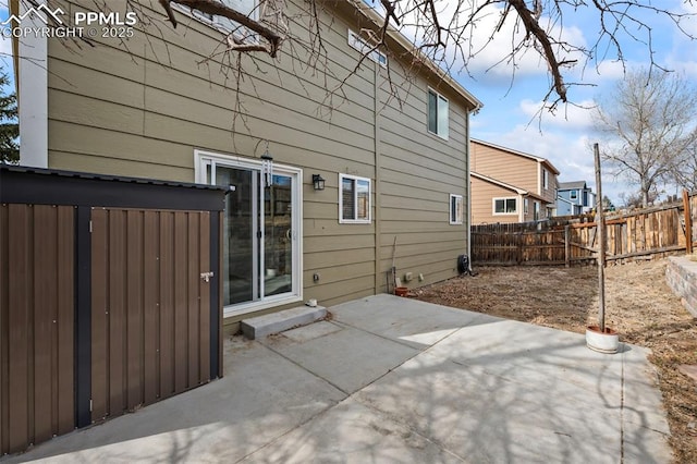 back of property with fence private yard and a patio area