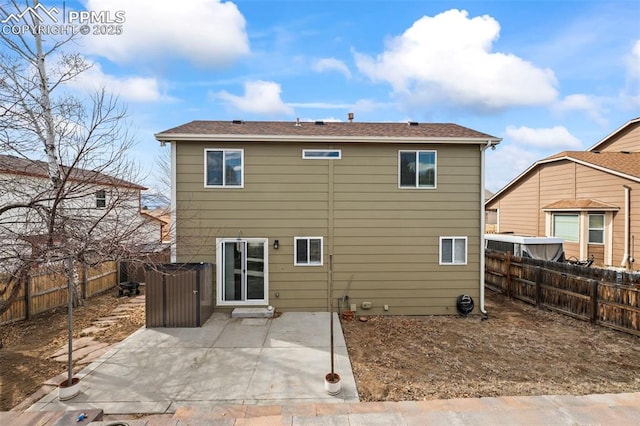 rear view of property featuring a patio area and a fenced backyard