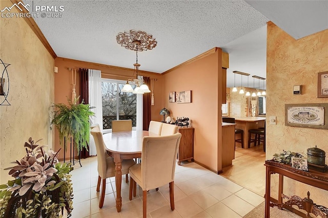 dining area featuring a textured wall, a notable chandelier, crown molding, and a textured ceiling