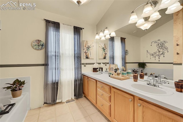 bathroom featuring lofted ceiling, double vanity, tile patterned flooring, and a sink