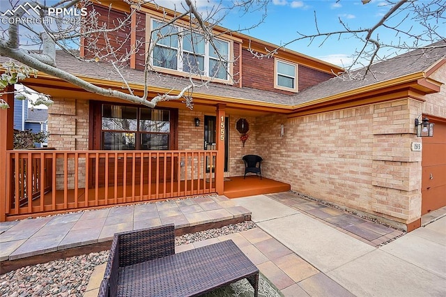 exterior space featuring a porch and brick siding