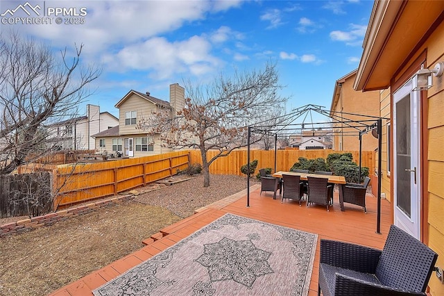 view of patio / terrace with a gazebo, a wooden deck, a fenced backyard, and outdoor dining space