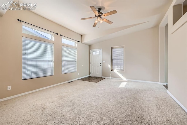 entryway with lofted ceiling, light colored carpet, ceiling fan, and baseboards