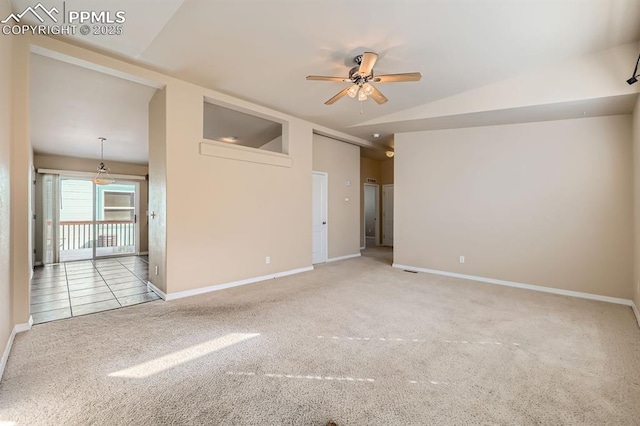 unfurnished room with lofted ceiling, light carpet, ceiling fan, and baseboards