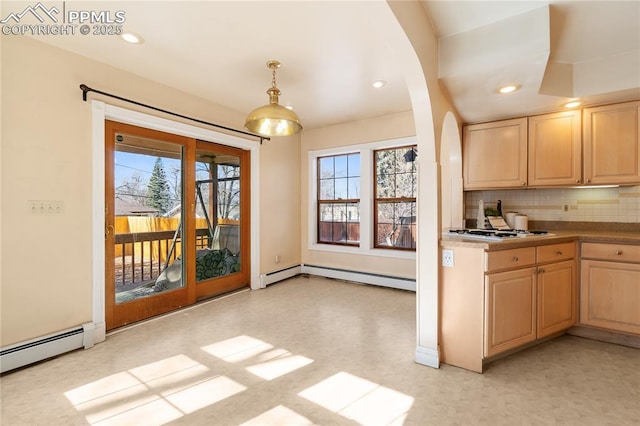 kitchen with a baseboard heating unit, light brown cabinetry, plenty of natural light, and pendant lighting