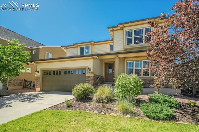 view of front of house featuring stone siding, driveway, and an attached garage