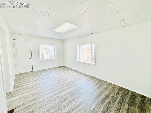 1108 W 16th St, Pueblo, CO 81003 - spare room featuring visible vents, wood finished floors, and a paneled ceiling