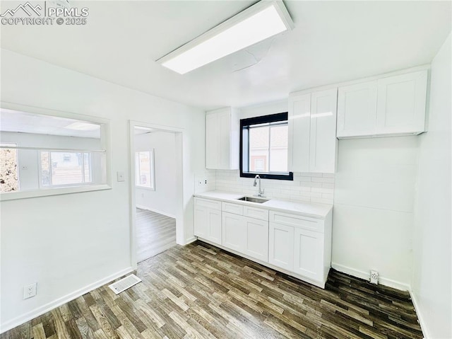 1108 W 16th St, Pueblo, CO 81003 - kitchen featuring light countertops, white cabinetry, a sink, and visible vents
