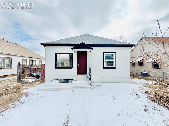 1108 W 16th St, Pueblo, CO 81003 - bungalow with a shingled roof, central AC, fence, and stucco siding
