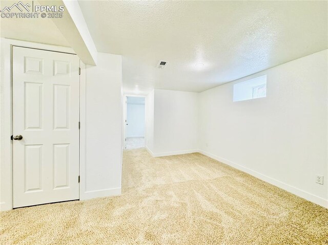 1108 W 16th St, Pueblo, CO 81003 - spare room featuring light carpet, a textured ceiling, visible vents, and baseboards