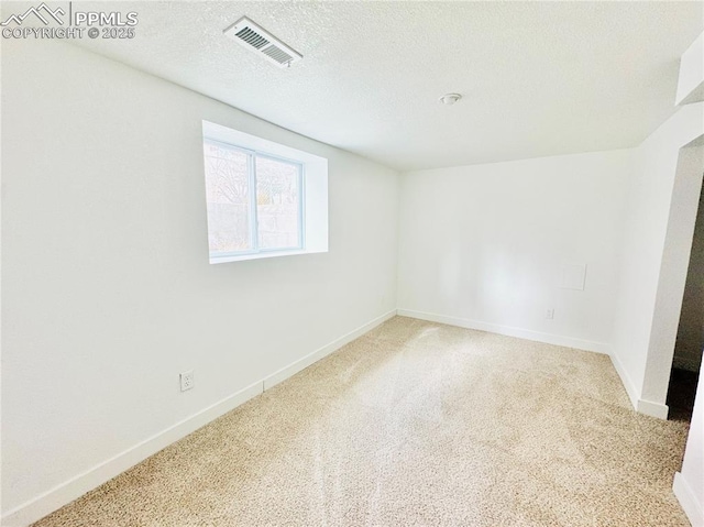 1108 W 16th St, Pueblo, CO 81003 - empty room with carpet, visible vents, a textured ceiling, and baseboards