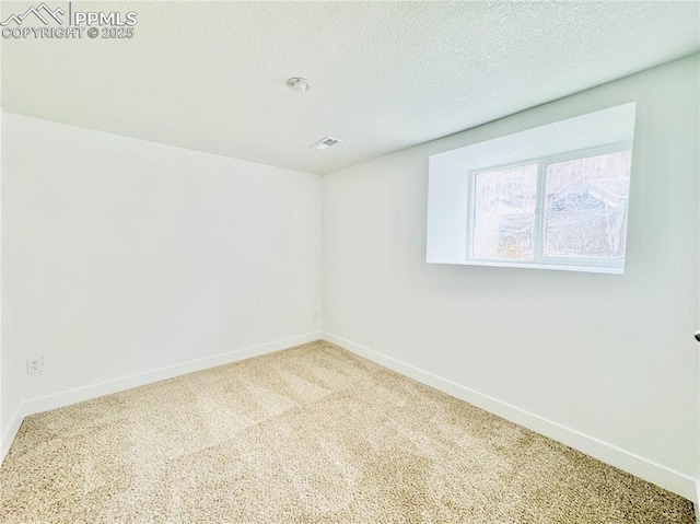 1108 W 16th St, Pueblo, CO 81003 - unfurnished room featuring baseboards, a textured ceiling, visible vents, and carpet flooring