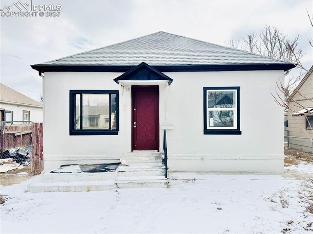 1108 W 16th St, Pueblo, CO 81003 - bungalow-style house with entry steps, a shingled roof, and fence