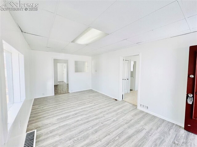 1108 W 16th St, Pueblo, CO 81003 - spare room with light wood finished floors, a paneled ceiling, and visible vents