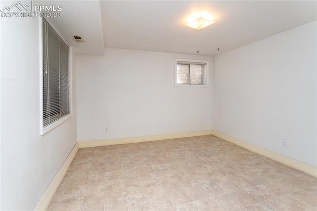 empty room with visible vents and baseboards