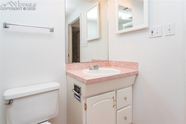 bathroom featuring toilet and vanity