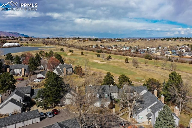 drone / aerial view with golf course view and a residential view