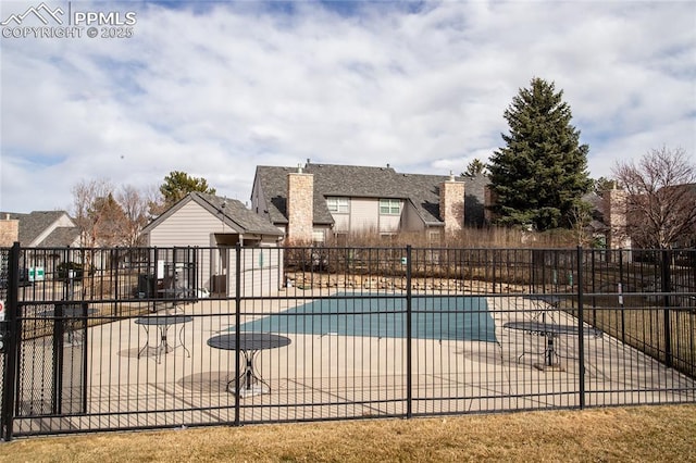 pool featuring a patio area and fence