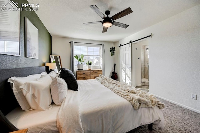 carpeted bedroom featuring a barn door, baseboards, a ceiling fan, a textured wall, and a textured ceiling