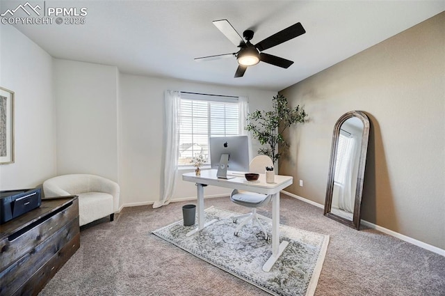 carpeted office space with a ceiling fan and baseboards