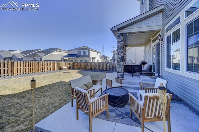 view of patio with a residential view, a fenced backyard, and outdoor lounge area