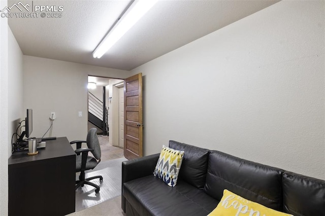 home office featuring light carpet and a textured ceiling