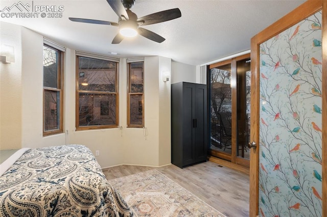 bedroom featuring light wood-type flooring and a ceiling fan