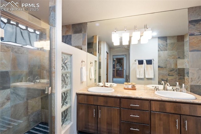 bathroom with double vanity, a sink, and a shower stall