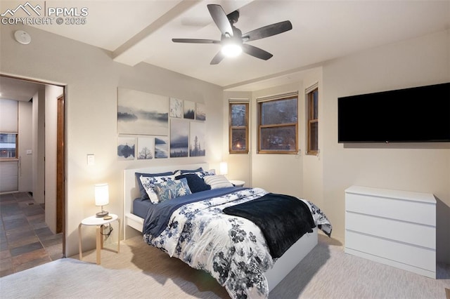 bedroom with beam ceiling, light colored carpet, and ceiling fan