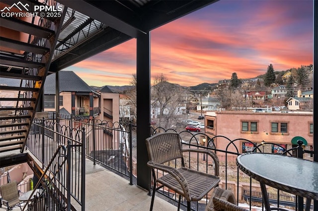 balcony at dusk with a residential view and a mountain view