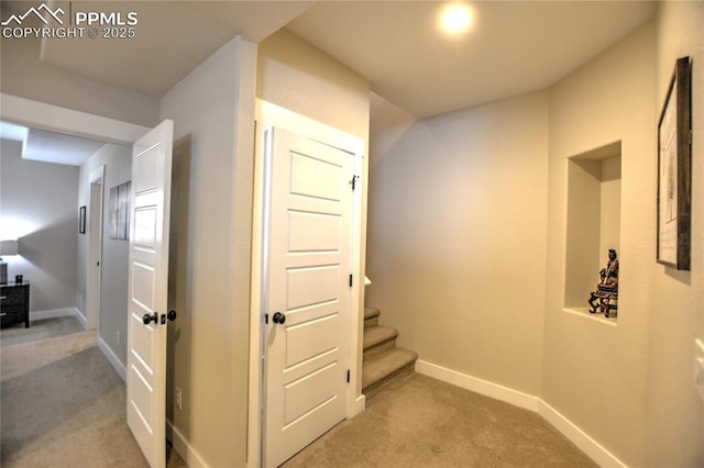 corridor with light carpet and baseboards