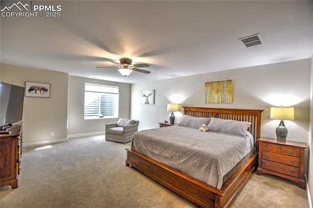 carpeted bedroom featuring ceiling fan, visible vents, and baseboards