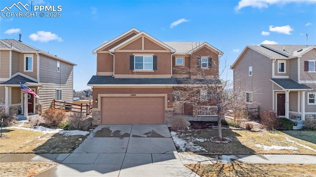 view of front of property featuring a garage, concrete driveway, stone siding, and stucco siding