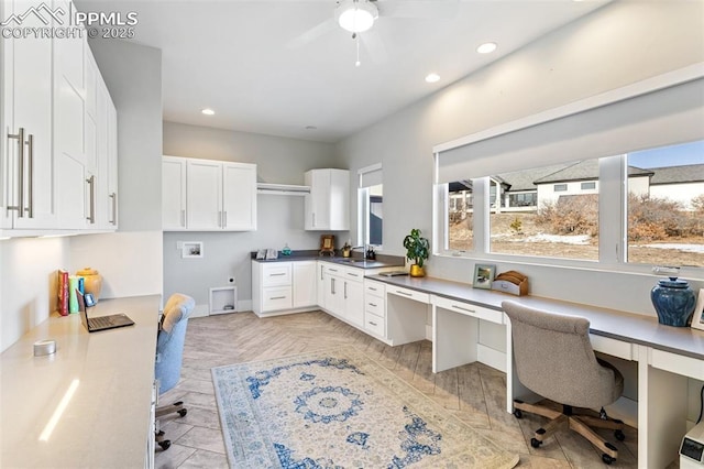 office area featuring a sink, ceiling fan, built in study area, and recessed lighting