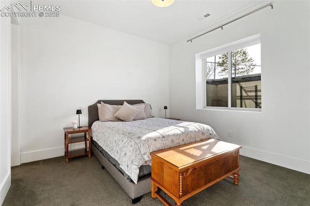 bedroom featuring dark colored carpet and baseboards