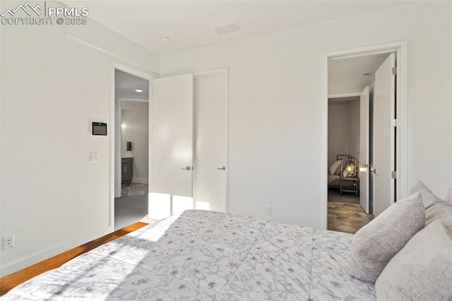 bedroom with baseboards and wood finished floors