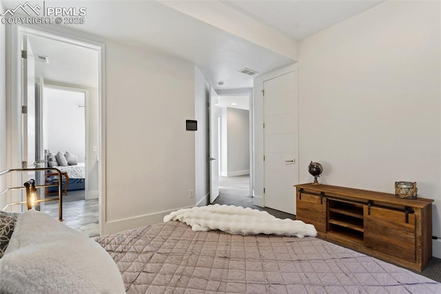 bedroom featuring visible vents and baseboards