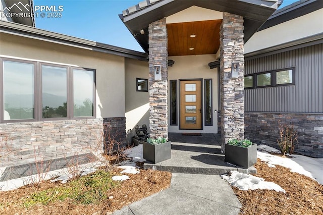 property entrance featuring stone siding and stucco siding