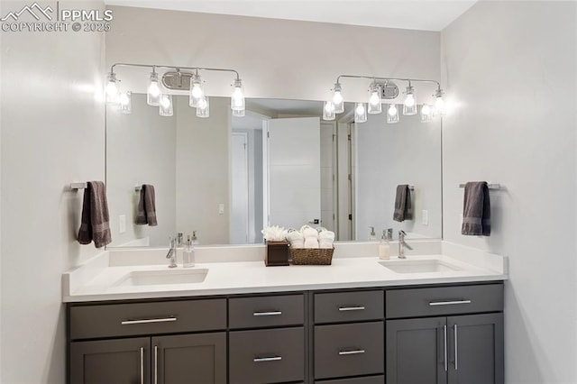 bathroom featuring a sink and double vanity