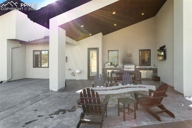 view of patio with area for grilling and outdoor wet bar